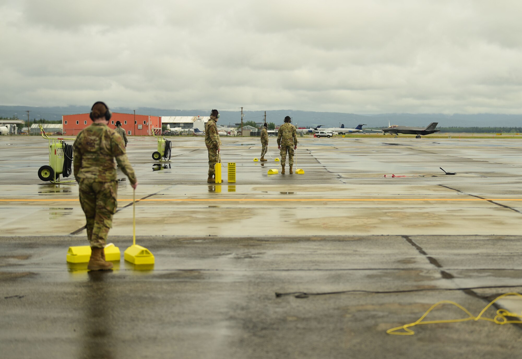 U.S. Air Force Airmen from the 356th Aircraft Maintenance Unit standby as an F-35A Lightning II assigned to the 356th Fighter Squadron taxis at the Fairbanks International Airport, June 24, 2020.