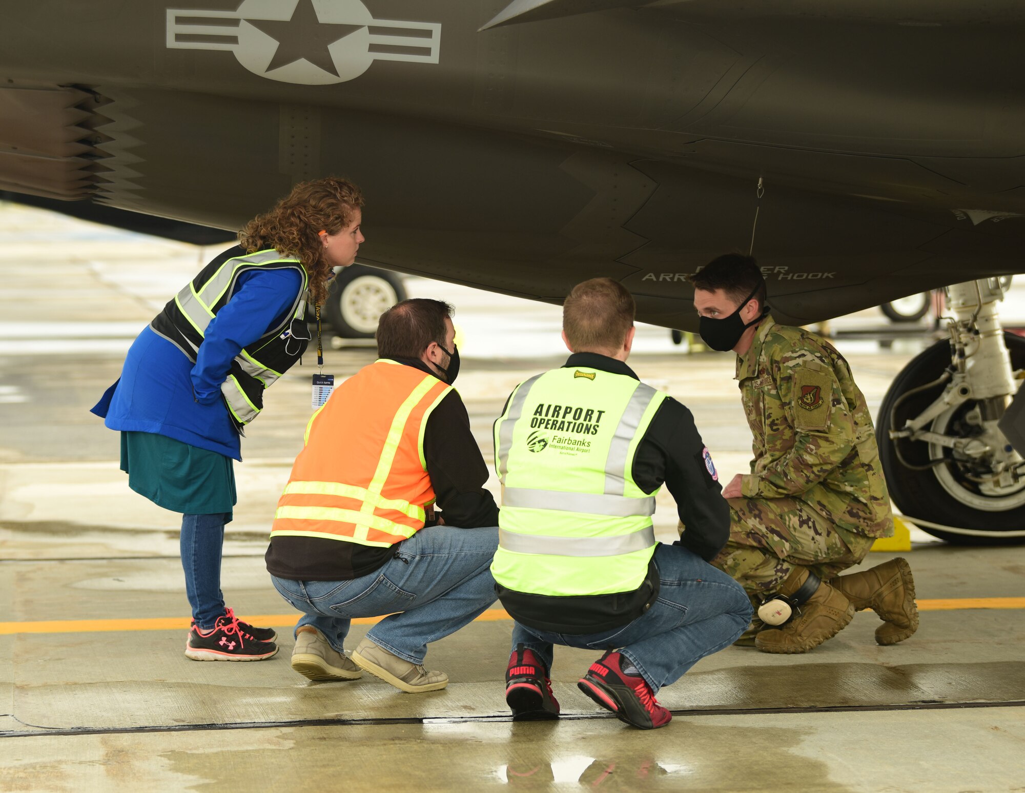 U.S. Air Force Tech. Sgt. Theodore Crowley, a 356th Aircraft Maintenance Unit F-35A Lightning II crew chief, explains some basic features and functions of the F-35A to representatives from Omni Logistics Inc. at the Fairbanks International Airport, June 24, 2020.