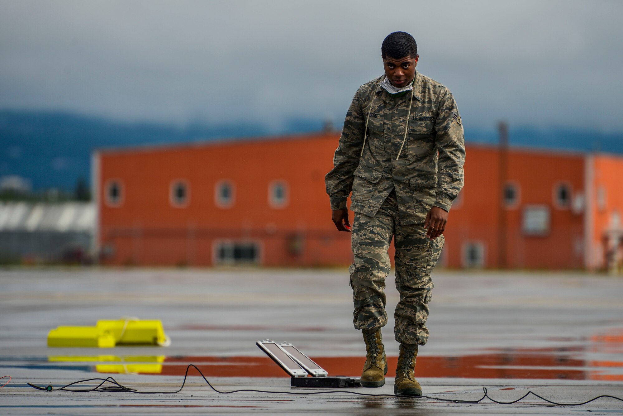 U.S. Air Force Airman 1st Class Scott Nabors, a 356th Aircraft Maintenance Unit (AMU) F-35A Lightning II crew chief, prepares for two U.S. Air Force F-35A Lightning IIs to land at Fairbanks International Airport, Alaska, June 24, 2020.