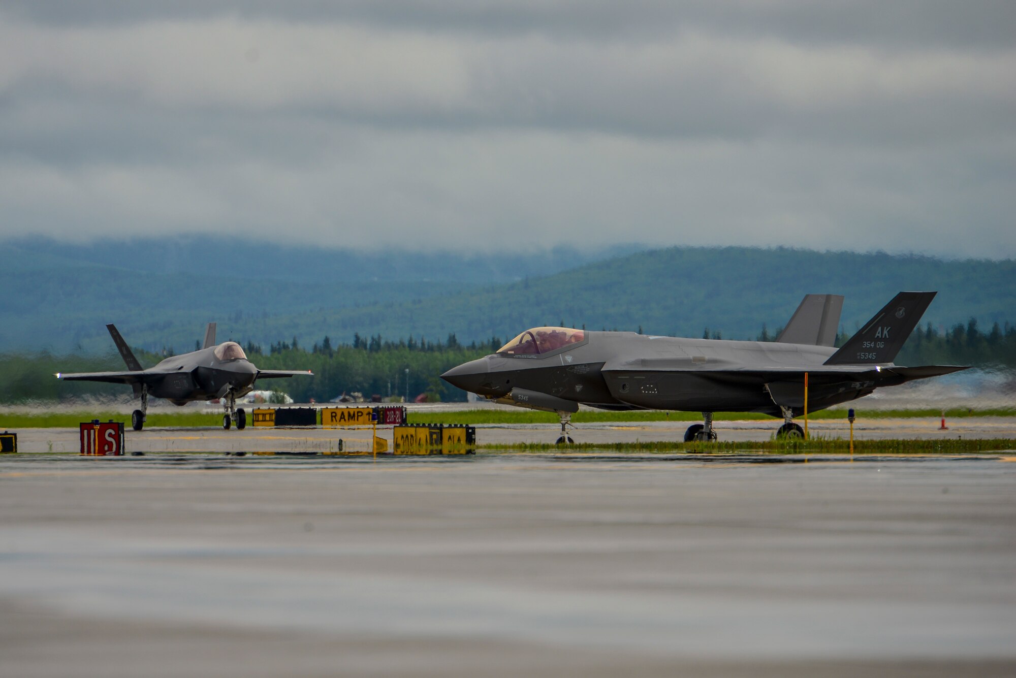 Two U.S. Air Force F-35A Lightning IIs assigned to the 356th Fighter Squadron taxi on the Fairbanks International Airport (FAI) runway at Fairbanks, Alaska, June 24, 2020.