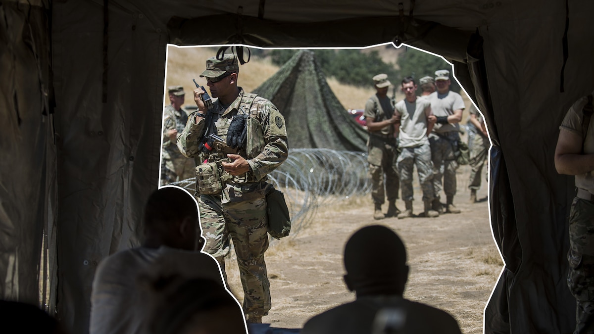 soldiers in a tent watching a scene outside.