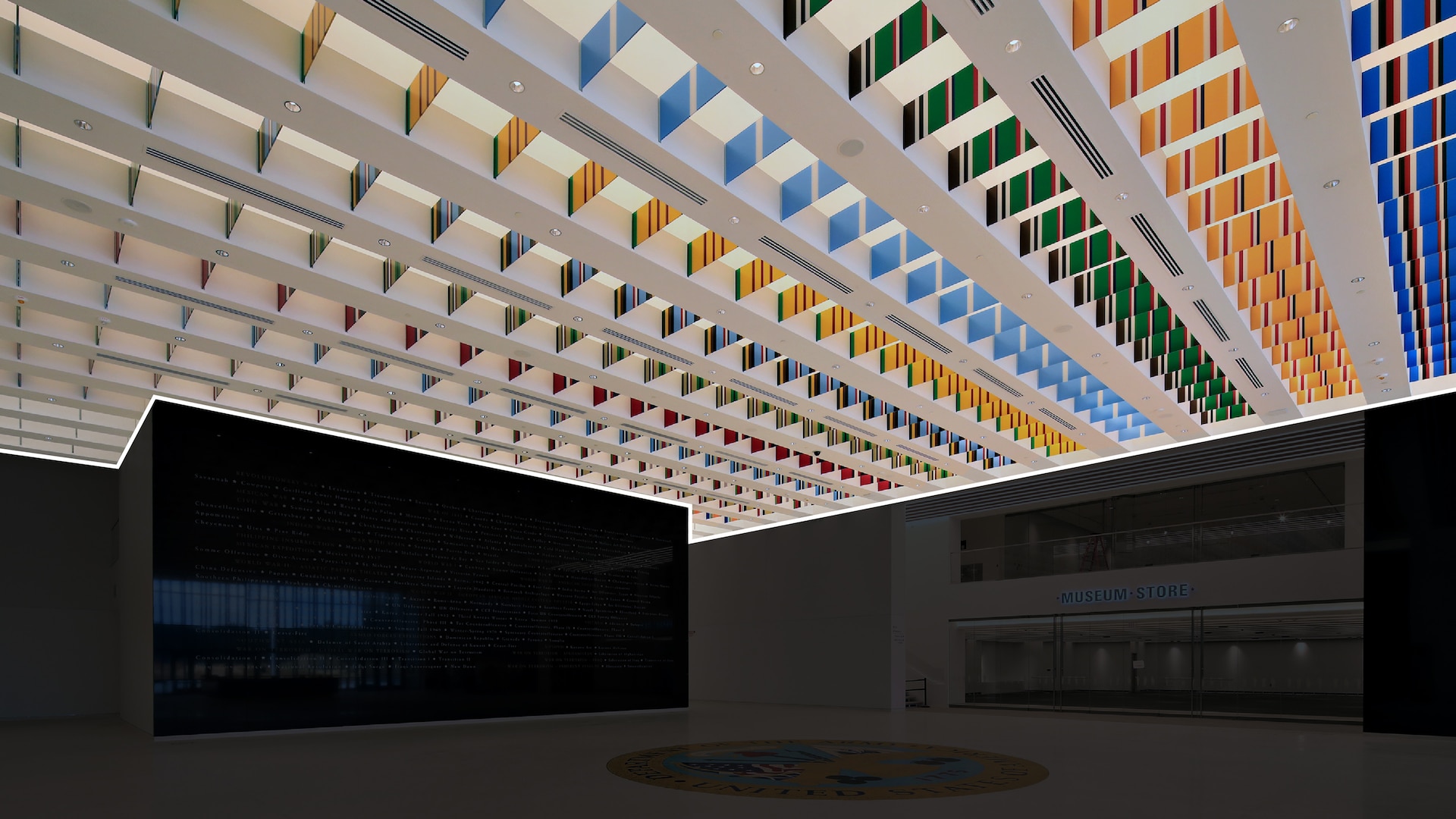 The ceiling installation shown has rows of colorful flags, all the same size and width.