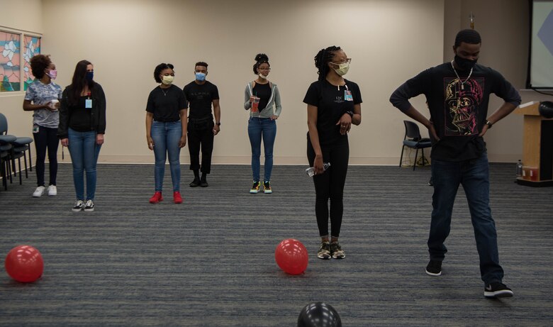 Individuals standing next to one another for a privilege exercise during Juneteenth celebration.