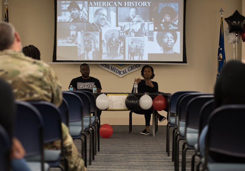 Individuals speaking to crowd at Juneteenth celebration.