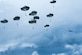 Battlefield Airmen assigned to the 3rd Air Support Operations Squadron descend after jumping from a HC-130J Combat King ll during airborne training over Malemute Drop Zone at Joint Base Elmendorf-Richardson, Alaska, June 24, 2020. The 3rd ASOS conducted the airborne training to maintain operational readiness. (U.S. Air Force photo by Senior Airman Jonathan Valdes Montijo)