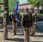 Lt. Col. Naim Lee holds the Army Acquisition Corps flag, as he is chartered as Product Manager, Soldier Clothing and Individual Equipment during the change of charter on Fort Belvoir, Virginia, June 12, 2020.