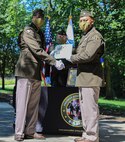 Lt. Col. Johnathan Allen receives the Meritorious Service Medal from Col. Stephen Thomas during the PdM SCIE change of charter on Fort Belvoir, Virginia, June 12, 2020.