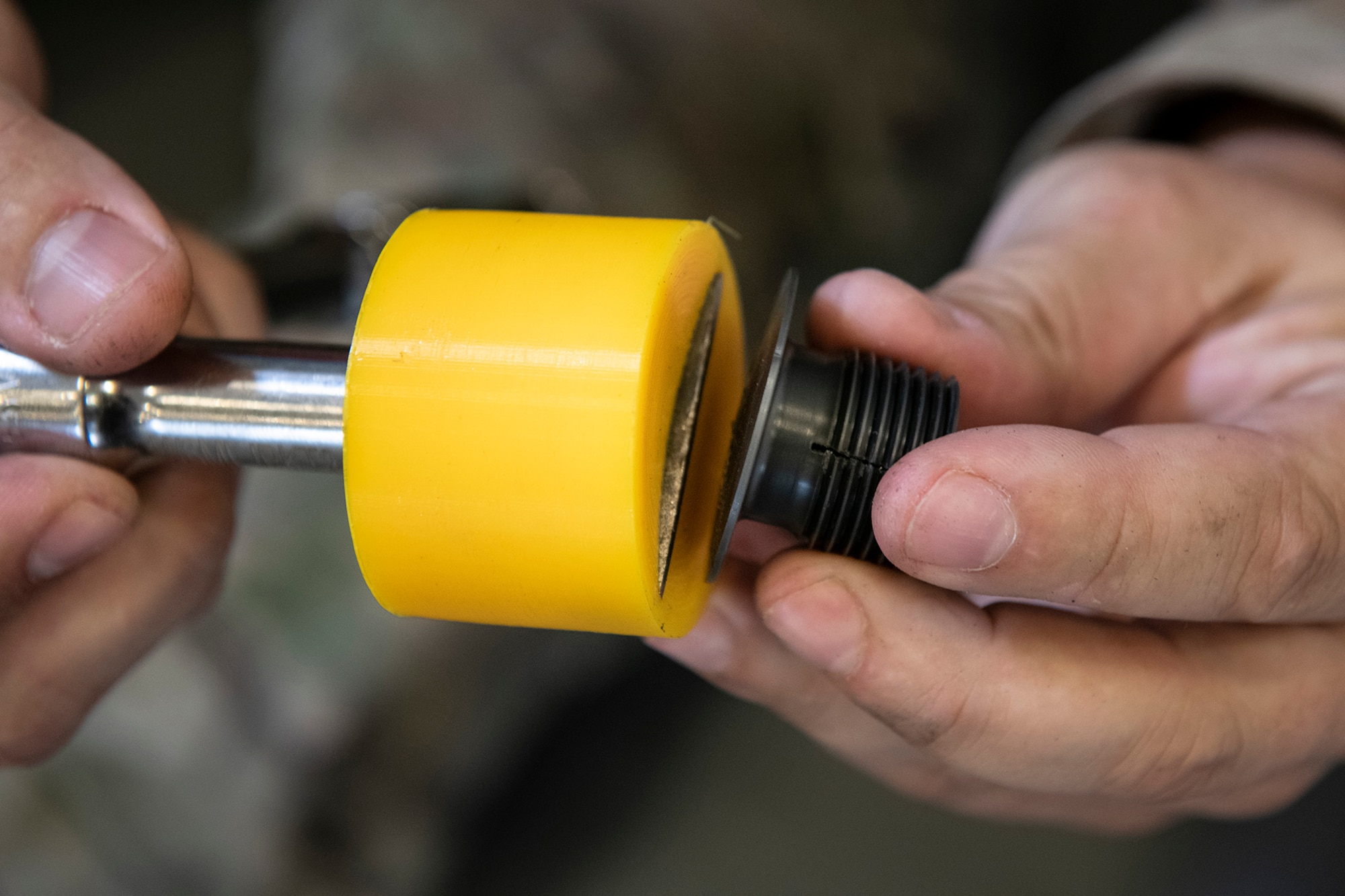 Tech. Sgt. Michael Resseguie, 919th Special Operations Maintenance Squadron metals technology craftsman, holds a 3D-printed jackpad plug removal tool at Duke Field, Florida, June 23, 2020.