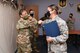 Col. Katrina Stephens, installation commander, bumps elbows with Airman 1st Class Alexandra Beruman-Alcaraz, 66th Air Base Group Commander Support Staff administrative specialist, following her promotion to senior airman below-the-zone during a ceremony at Hanscom Air Force Base, Mass., June 26. The BTZ program awards exceptional junior enlisted Airmen by promoting them six months early. (U.S. Air Force photo by Linda Labonte Britt).