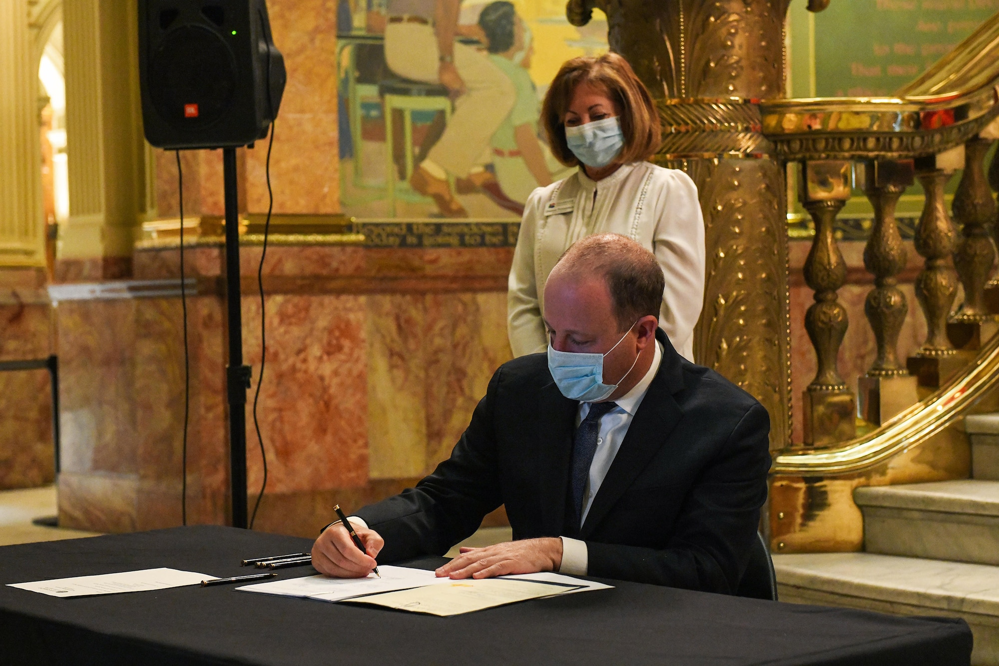 Colorado Gov. Jared Polis signs the Colorado House Bill 20-1326 at the Colorado State Capitol Building in Denver, June 25, 2020.