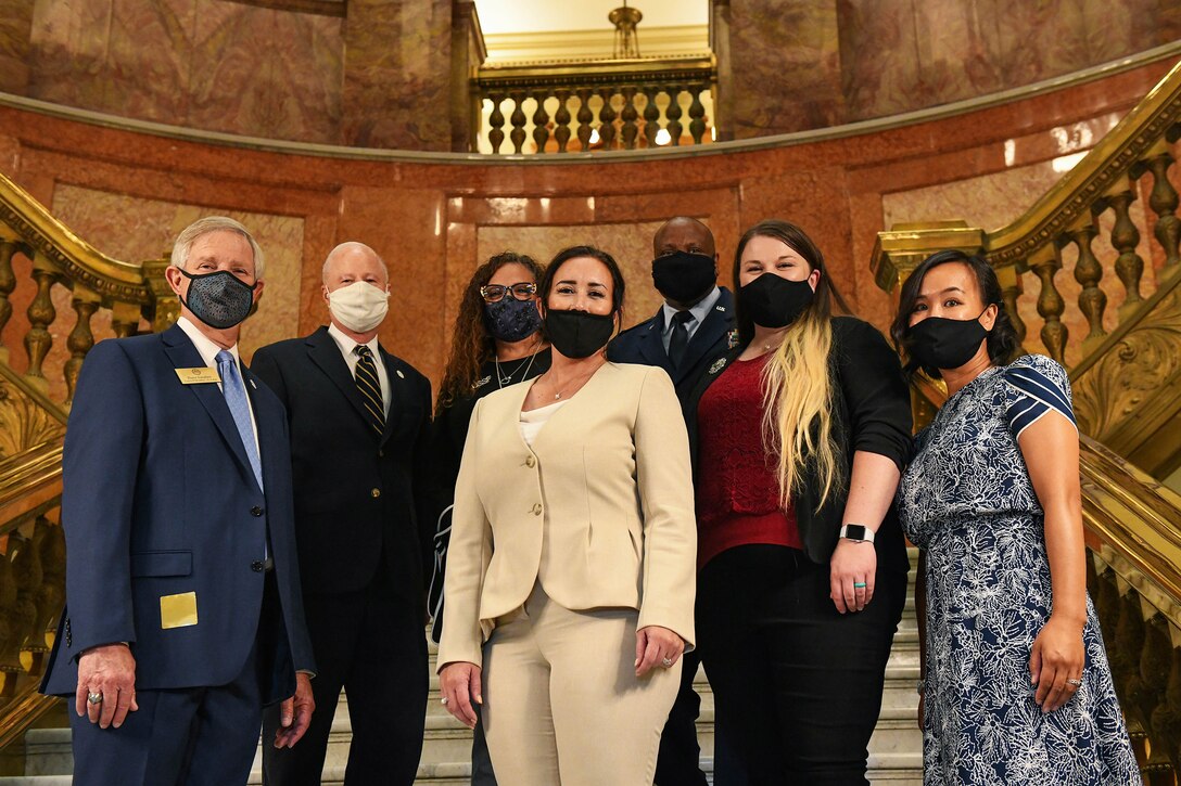 Attendants of the Colorado House Bill 20-1326 signing pose for a group photo at the Colorado State Capitol Building in Denver, June 25, 2020.