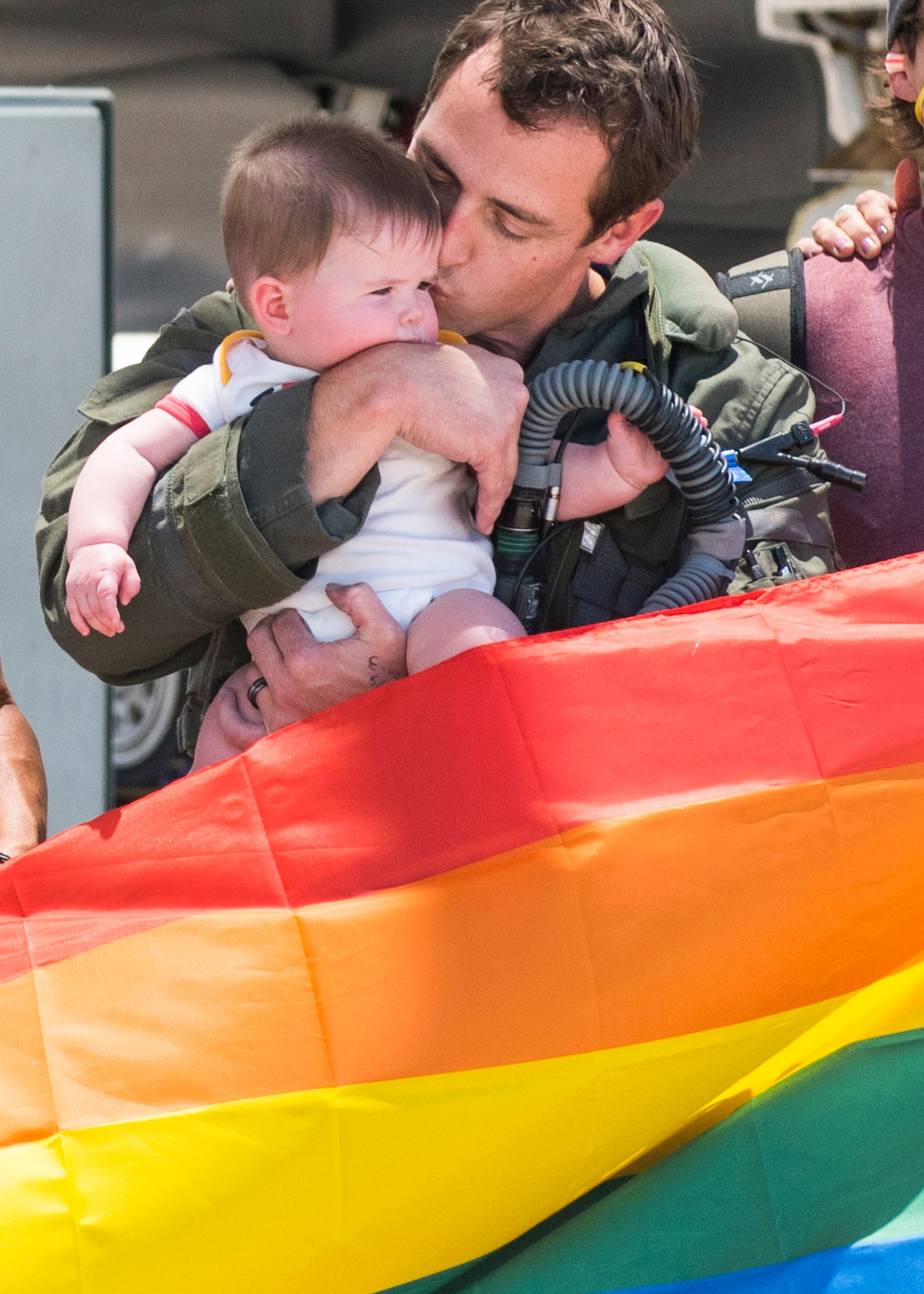 Maj. Tyler McBride, 62nd Fighter Squadron F-35A Lightning II instructor pilot, embraces his daughter after a Pride Month flyby June 26, 2020, at Luke Air Force Base, Ariz.