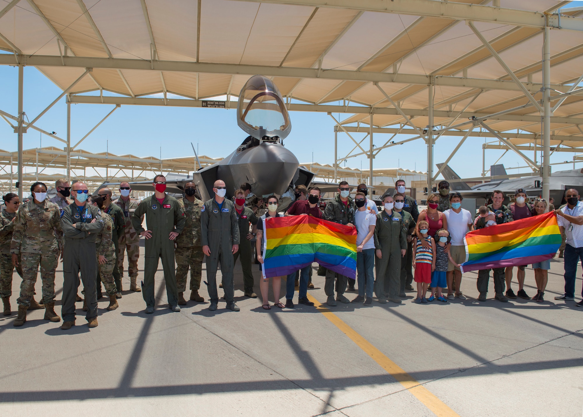 Airmen pose on the flightline after a Pride Month flyby June 26, 2020, at Luke Air Force Base, Ariz.
