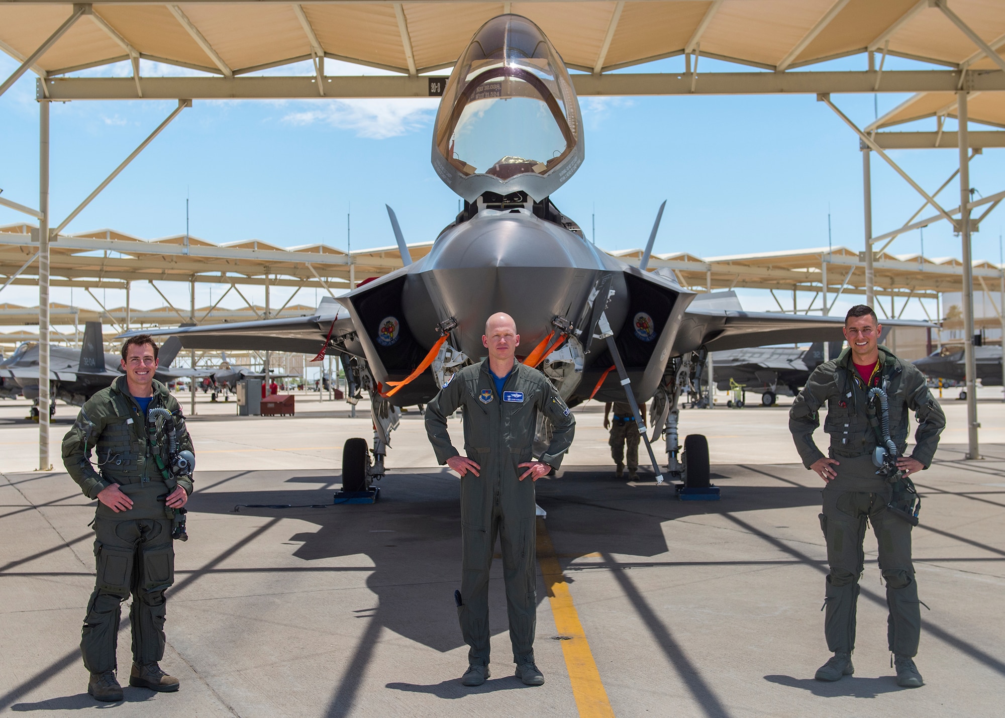 From left to right: Maj. Tyler McBride, 62nd Fighter Squadron F-35A Lightning II instructor pilot (left), Lt. Col. Chris Hubbard, 62nd Fighter Wing commander, and Capt. Justin Lennon, 56th Training Squadron F-35 instructor pilot, stand in front of an F-35 after a Pride Month flyby June 26, 2020, at Luke Air Force Base, Ariz.