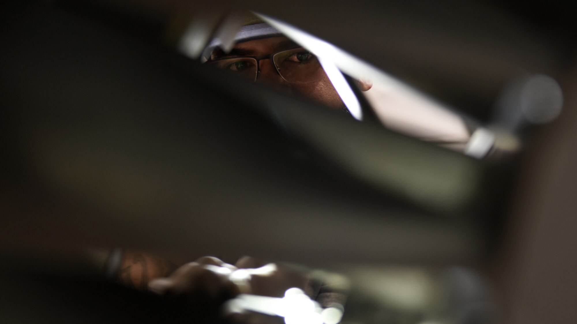 photo of an engine mechanic performing maintenance on an aircraft engine