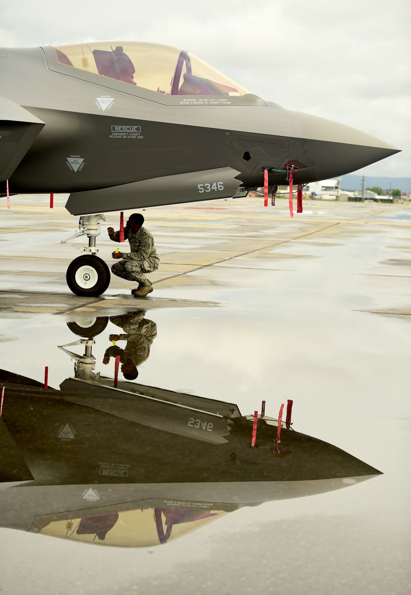 U.S. Air Force Airman 1st Class Scott Nabors, a 356th Aircraft Maintenance Unit F-35A Lightning II crew chief, inspects the aircraft after landing at the Fairbanks International Airport, June 24, 2020.