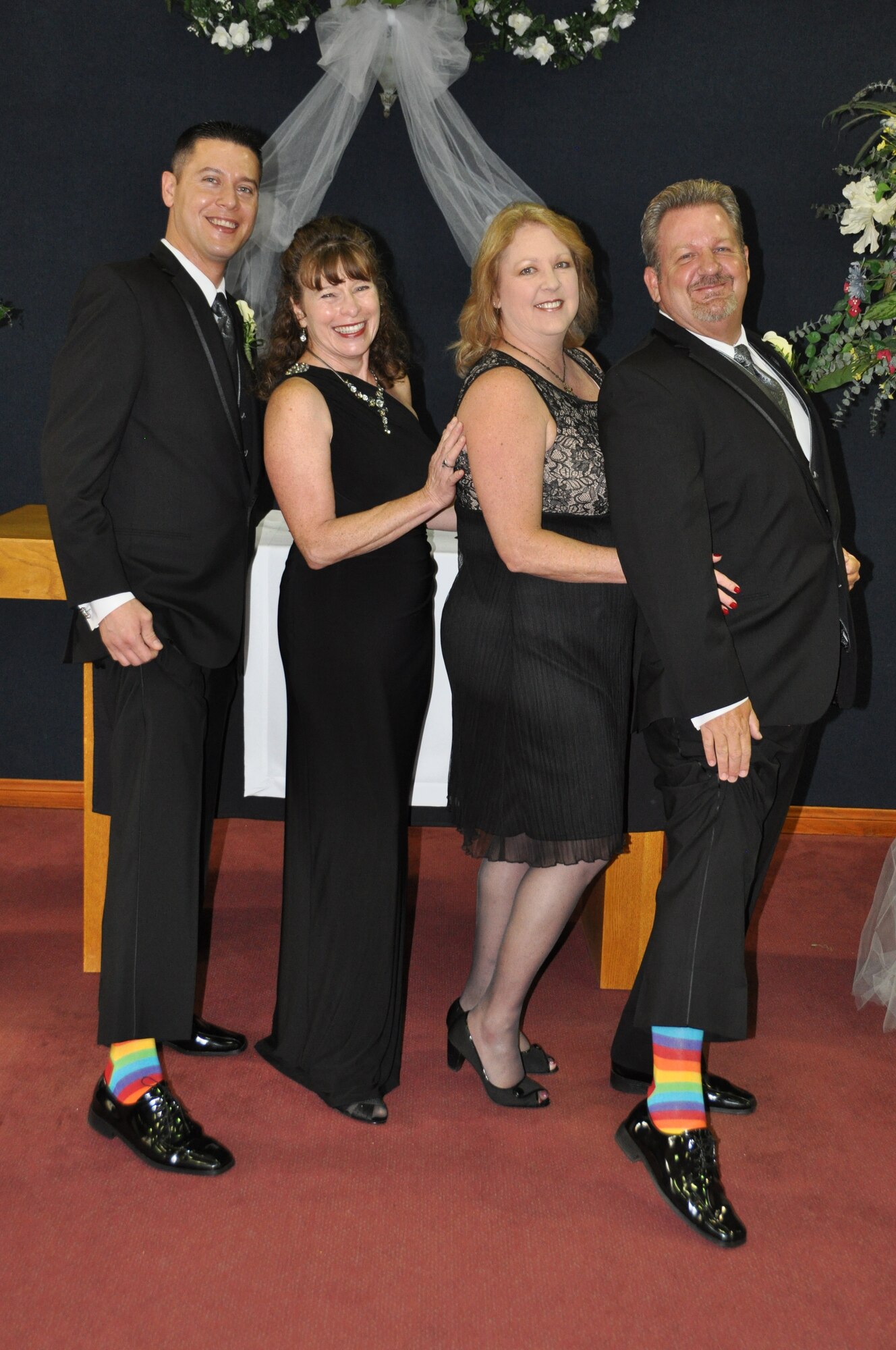(From left) Joshua Delgado, Sandy Ingersoll (Delgado's mother), Kimberly Brown, and Marvin Tucker, emergency manager, 452nd Air Mobility Wing and Brown's brother, pose at the alter after Delgado and Tucker became the first same-sex couple to be married in the historic March Air Reserve Base chapel on Aug. 3, 2013.