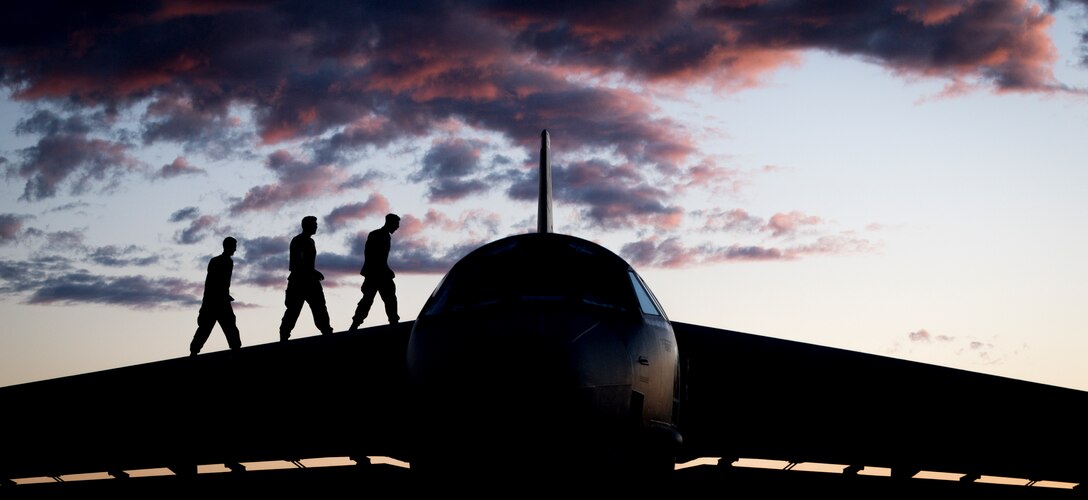 Staff Sgt. Jacob Lieuallen, Senior Airman Tommy Chase and Airman 1st Class Nathan Fanny, 96th Aircraft Maintenance Unit crew chiefs, pose for a photo on top of a B-52H Stratofortress at Eielson Air Force Base, Alaska, June 17, 2020. Bomber Task Force missions enable crews to maintain a high state of readiness and proficiency and validate the always-ready global strike capability. (U.S. Air Force photo by Senior Airman Lillian Miller)