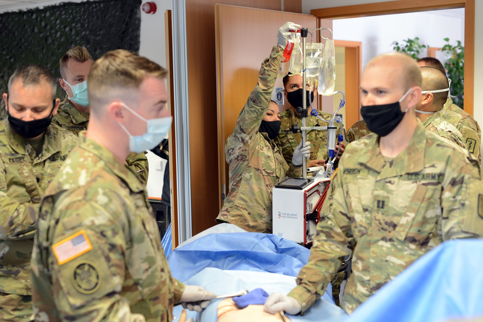 U.S. Army Spec. Alexandra Jimenez, 67th Forward Resuscitative Surgical Team licensed practical nurse hangs notional blood on the Belmont Rapid Infuser during a training scenario at the Medical Simulation Training Center, Ramstein Air Base, June 19, 2020.