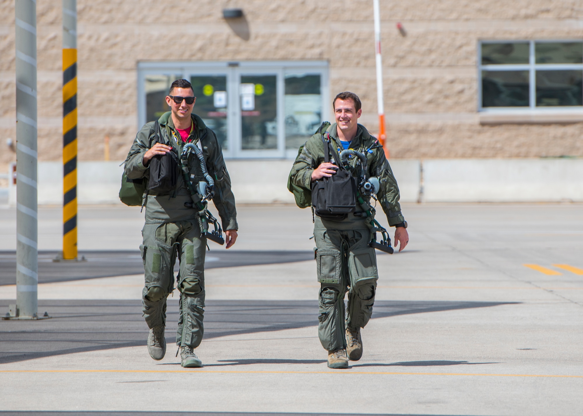Capt. Justin Lennon (left), 56th Training Squadron F-35 instructor pilot, and Maj. Tyler McBride, 62nd Fighter Squadron F-35A Lightning II instructor pilot, walk to their F-35s ahead of a Pride Month flyby June 26, 2020, at Luke Air Force Base, Ariz.