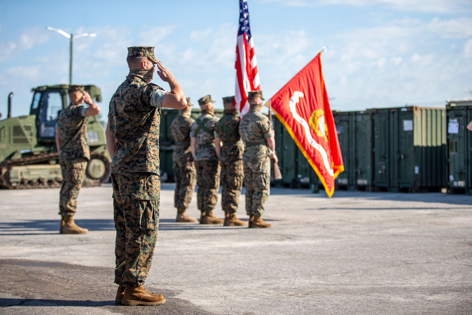 U.S. Marines salute the unit colors during the opening ceremony of SPMAGTF-SC, June 26.