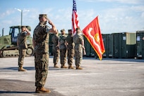 U.S. Marines salute the unit colors during the opening ceremony of SPMAGTF-SC, June 26.