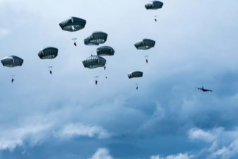 Battlefield Airmen assigned to the 3rd Air Support Operations Squadron descend after jumping from a HC-130J Combat King ll during airborne training over Malemute Drop Zone at Joint Base Elmendorf-Richardson, Alaska, June 24, 2020. The 3rd ASOS conducted the airborne training to maintain operational readiness. (U.S. Air Force photo by Senior Airman Jonathan Valdes Montijo)