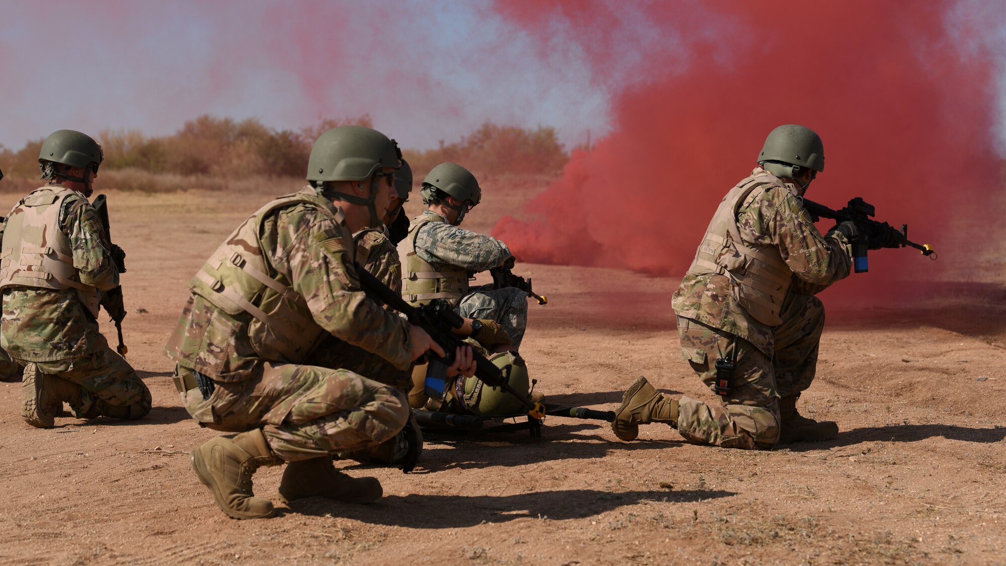 Airmen assigned to the 355th Civil Engineer Squadron simulate an air rescue during a training scenario at Davis-Monthan Air Force Base, Ariz., June 22, 2020. The unit was conducting training on Humvee convoy, land navigation, defensive fighting positions and integrated base defense. (U.S. Air Force photo by Staff Sgt. Sergio A. Gamboa)