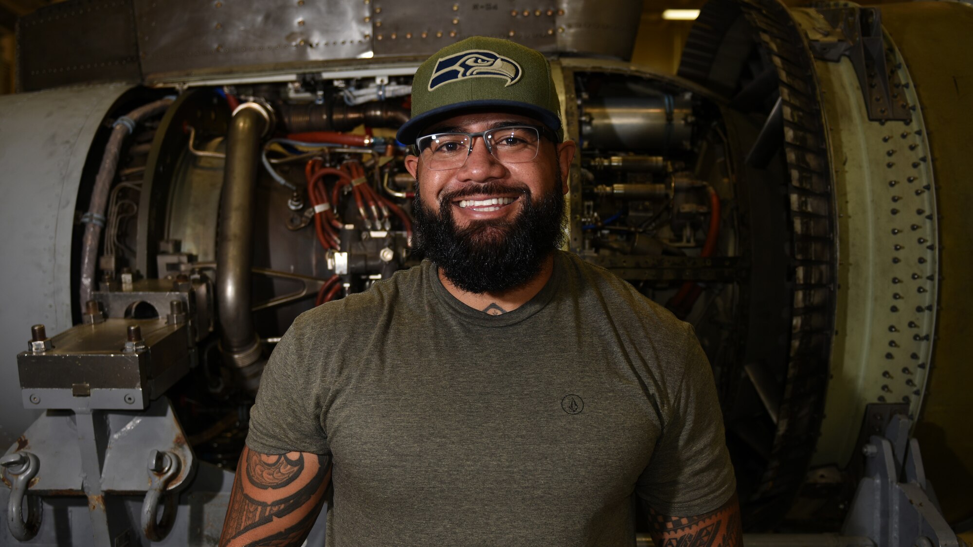 Photo of an engine mechanic in front of an aircraft engine