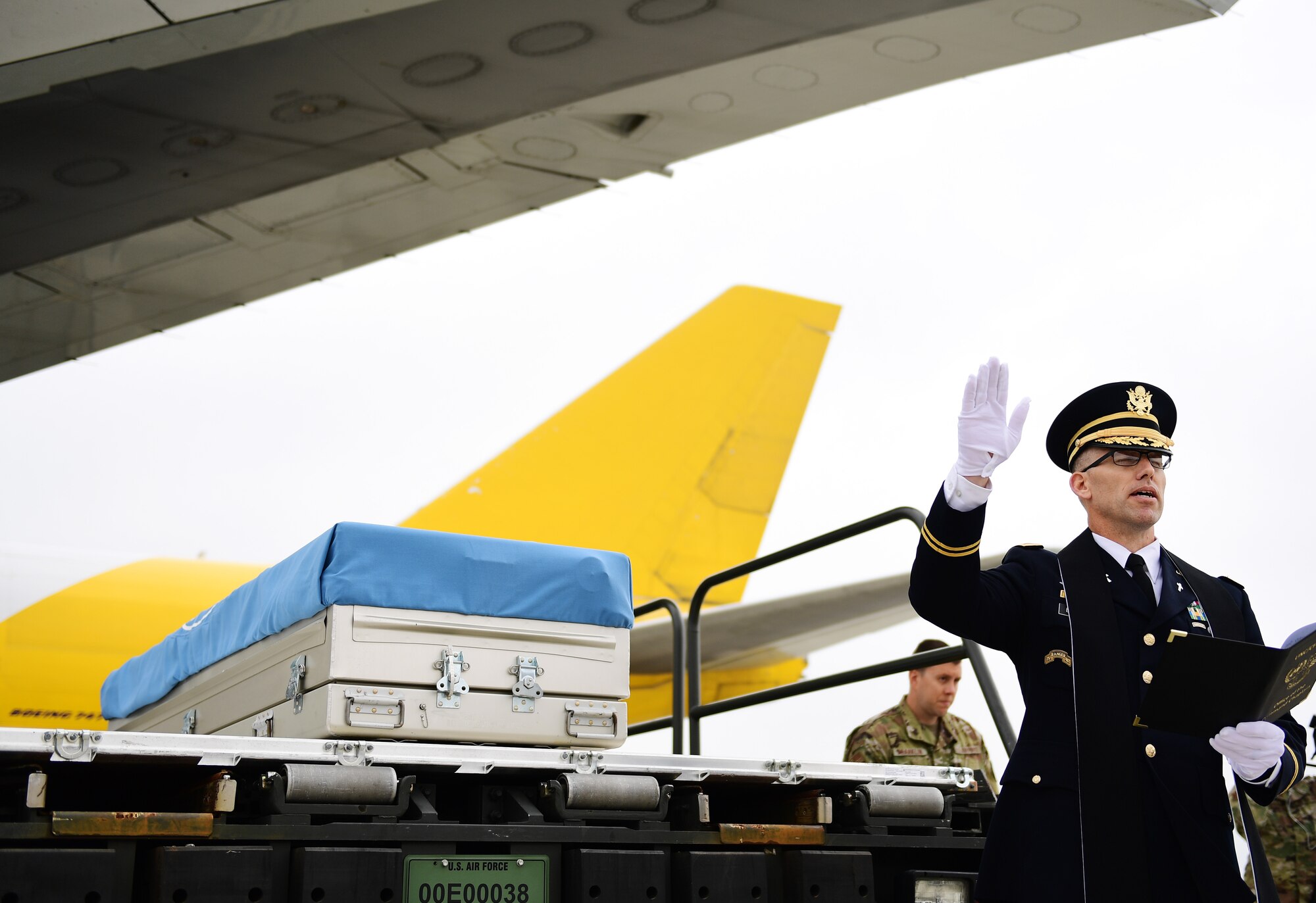 A chaplain says a prayer during a repatriation ceremony