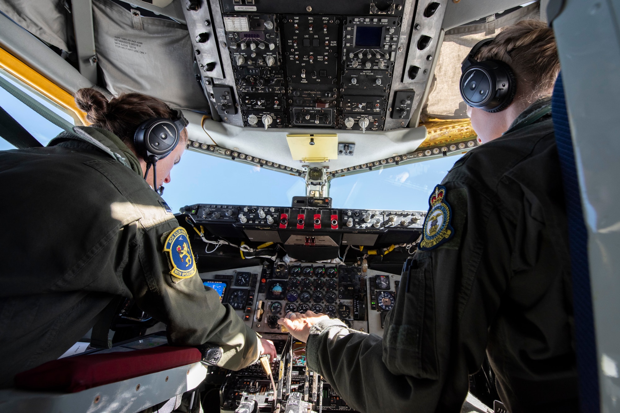 Capt. Marissa Hartoin, 100th Operations Support Squadron chief of wing tactics and instructor pilot, left, and 1st Lt. Elizabeth Avara, 351st Air Refueling Squadron pilot, fly a KC-135 Stratotanker over the North Sea June 18, 2020. The aircrew supported B-2 Spirits from Whiteman Air Force Base, Missouri, by providing aerial refueling during their long range training mission. (U.S. Air Force photo by Airman 1st Class Joseph Barron)