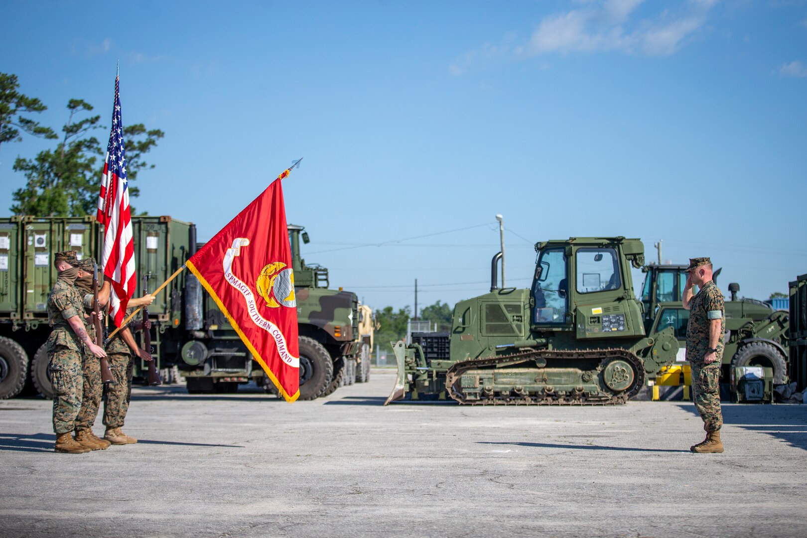 A U.S. Marine salute the unit colors during the opening ceremony of SPMAGTF-SC, June 26.