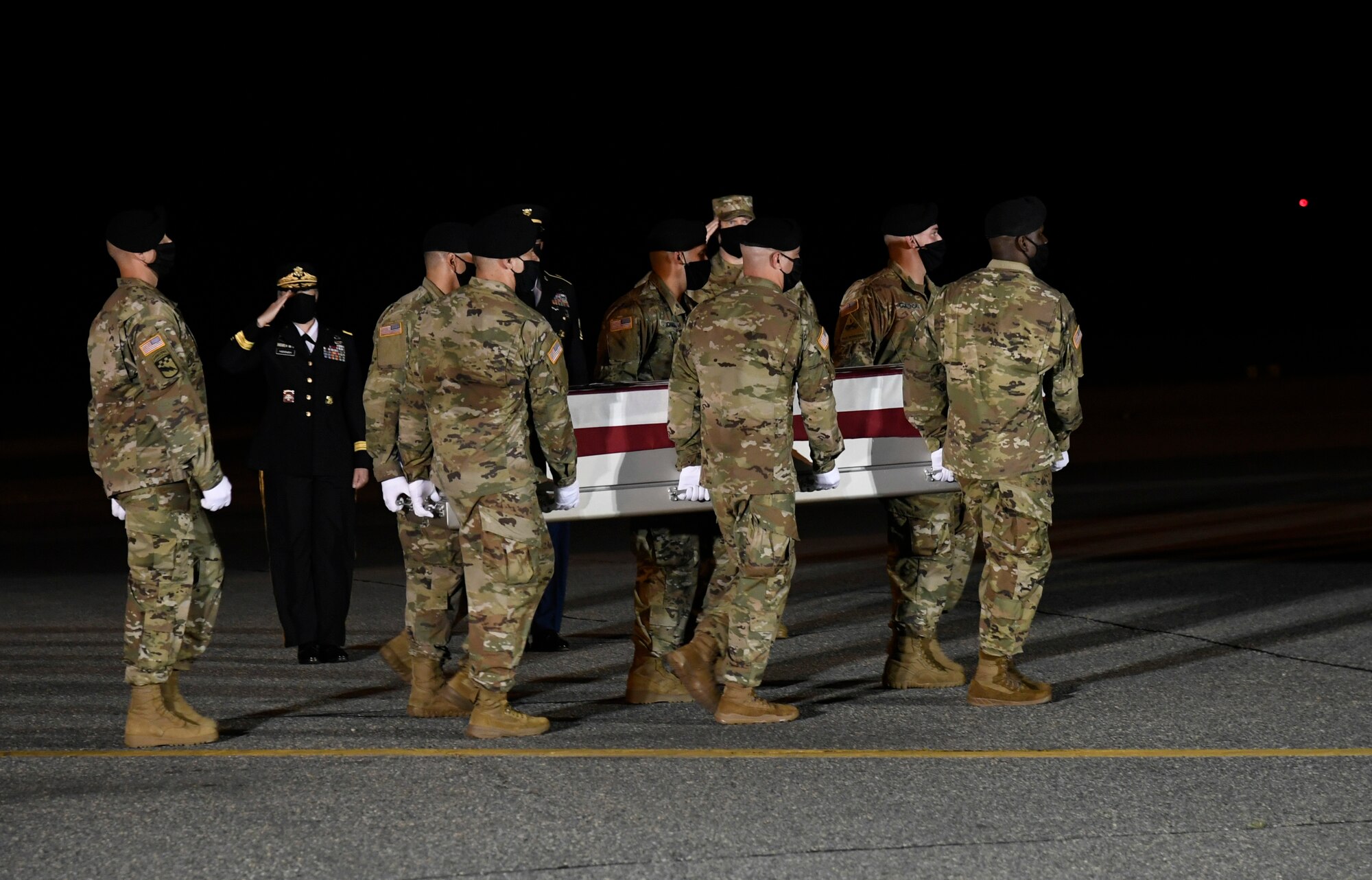 A U.S. Army carry team transfers the remains of Spc. Nick Bravo Regules of Largo, Florida, during a dignified transfer June 27, 2020, at Dover Air Force Base, Delaware. Bravo Regules was assigned to 2nd Battalion, 43rd Air Defense Artillery Regiment, 11th Air Defense Artillery Brigade, Fort Bliss, Texas. (U.S. Air Force photo by Senior Airman Eric M. Fisher)