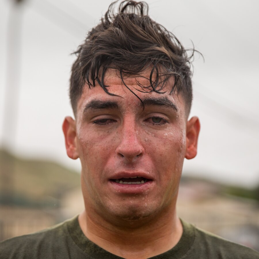 U.S. Marine Corps Lance Cpl. Israel Garcia, a field artillery cannoneer with India Battery, Battalion Landing Team 1/4, 15th Marine Expeditionary Unit, poses for a portrait after receiving oleoresin capsicum spray during a non-lethal weapons course at Marine Corps Base Camp Pendleton, California, June 23, 2020. The non-lethal weapons course teaches Marines escalation of force tactics, techniques and procedures. (U.S. Marine Corps photo by Lance Cpl. Brendan Mullin)
