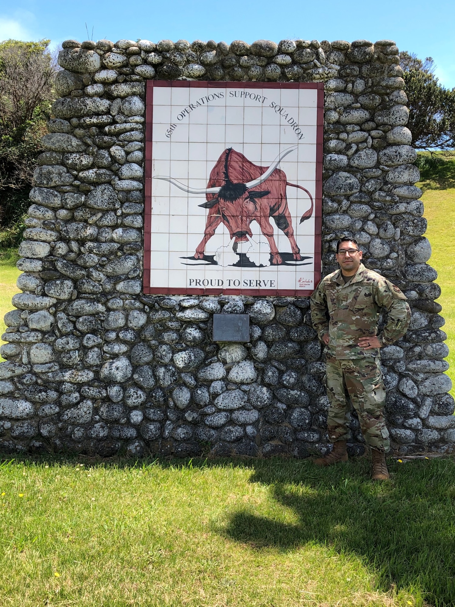 U.S. Air Force Master Sgt. Carlos Torres, 65th Air Base Squadron maintenance superintendent, poses for a photo near his unit's mural. Torres received the Ramstein Air Base Airlifter of the Week award in recognition for his efforts made throughout COVID-19. (Courtesy photo by Master Sgt. Torres)