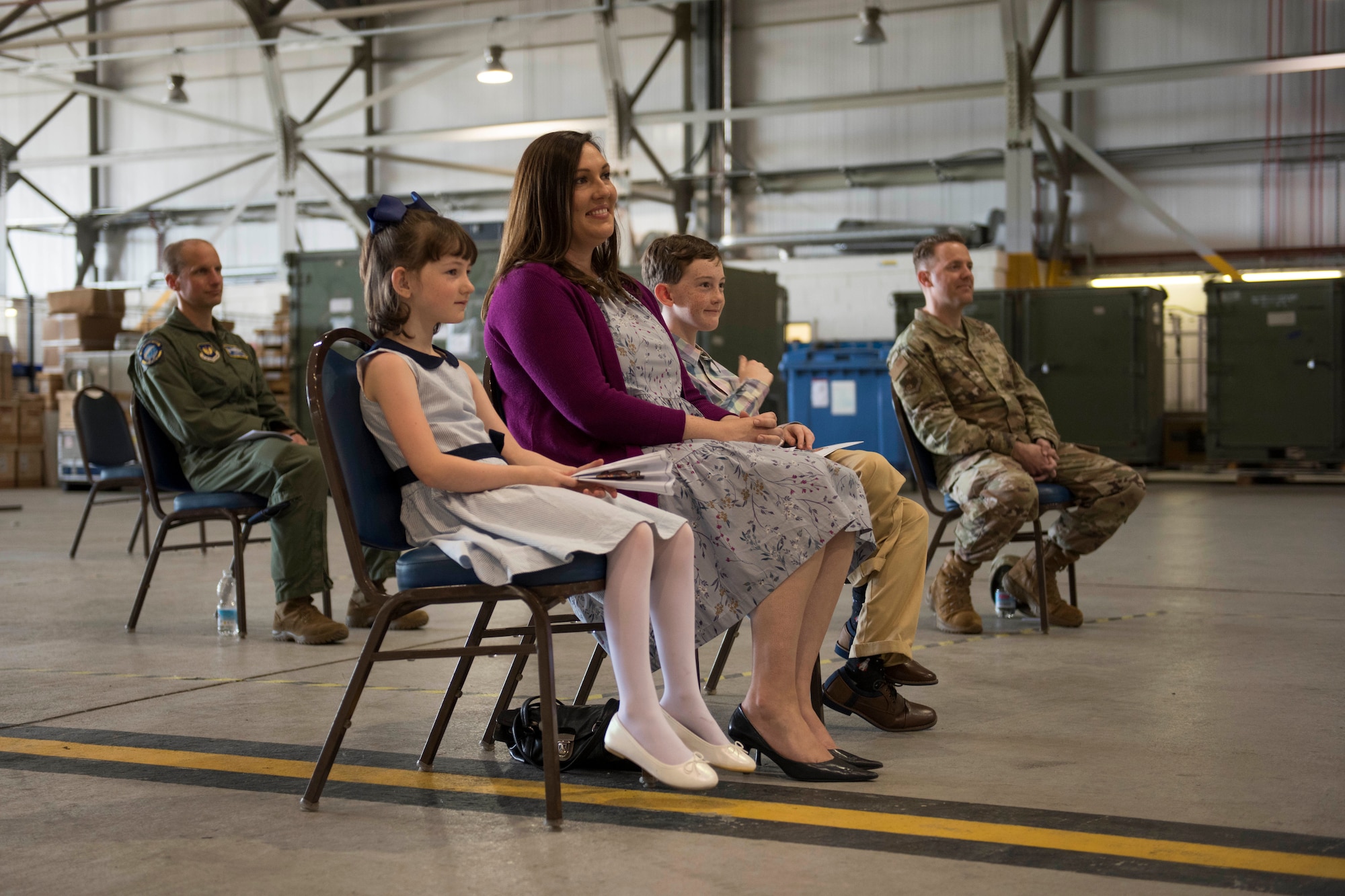 U.S. Air Force Lt. Col. Brian Staniszewski’s wife and children watch as he assumes command of the 99th Expeditionary Reconnaissance Squadron, during a change of command ceremony, at RAF Fairford, England, June 24, 2020. The change of command ceremony is a military tradition that represents a formal transfer of a unit’s authority and responsibility from one commander to another. (U.S. Air Force photo by Airman 1st Class Jennifer Zima)