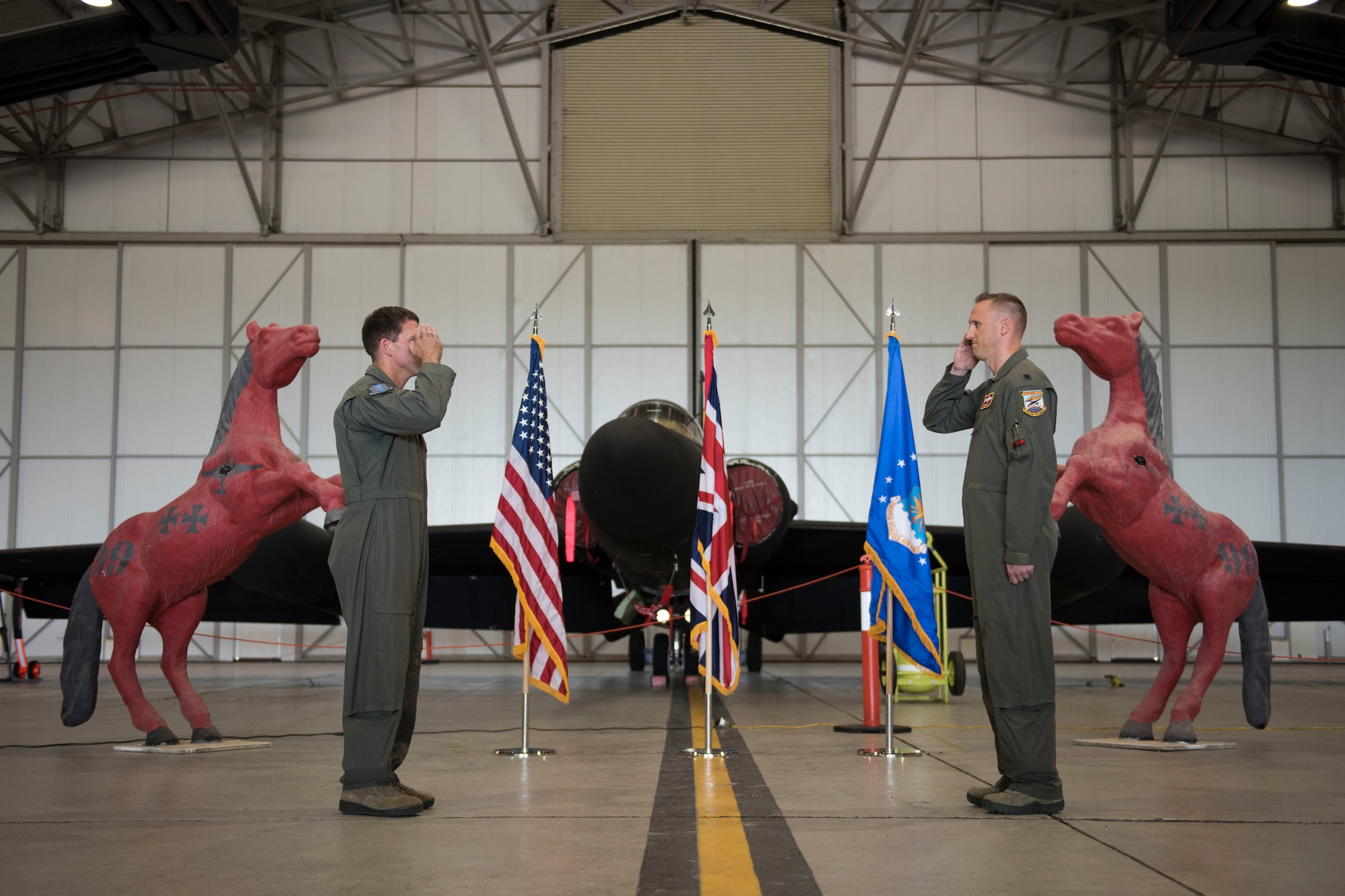 U.S. Air Force Lt. Col. Peter Gryn, right, outgoing 99th Expeditionary Reconnaissance Squadron commander, receives The Meritorious Service Medal from Col. Jason Camilletti, left, 48th Operations Group commander and presiding officer, during a change of command ceremony, at RAF Fairford, England, June 24, 2020. The change of command ceremony is a military tradition that represents a formal transfer of a unit’s authority and responsibility from one commander to another. (U.S. Air Force photo by Airman 1st Class Jennifer Zima)