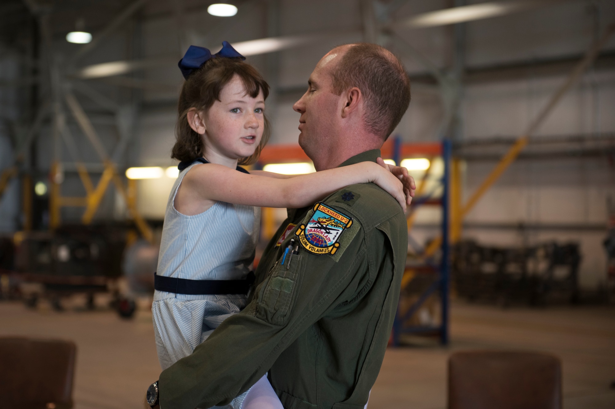 U.S. Air Force Lt. Col. Brian Staniszewski, 99th Expeditionary Reconnaissance Squadron commander, embraces his daughter during a change of command ceremony, at RAF Fairford, England, June 24, 2020. The change of command ceremony is a military tradition that represents a formal transfer of a unit’s authority and responsibility from one commander to another. (U.S. Air Force photo by Airman 1st Class Jennifer Zima)