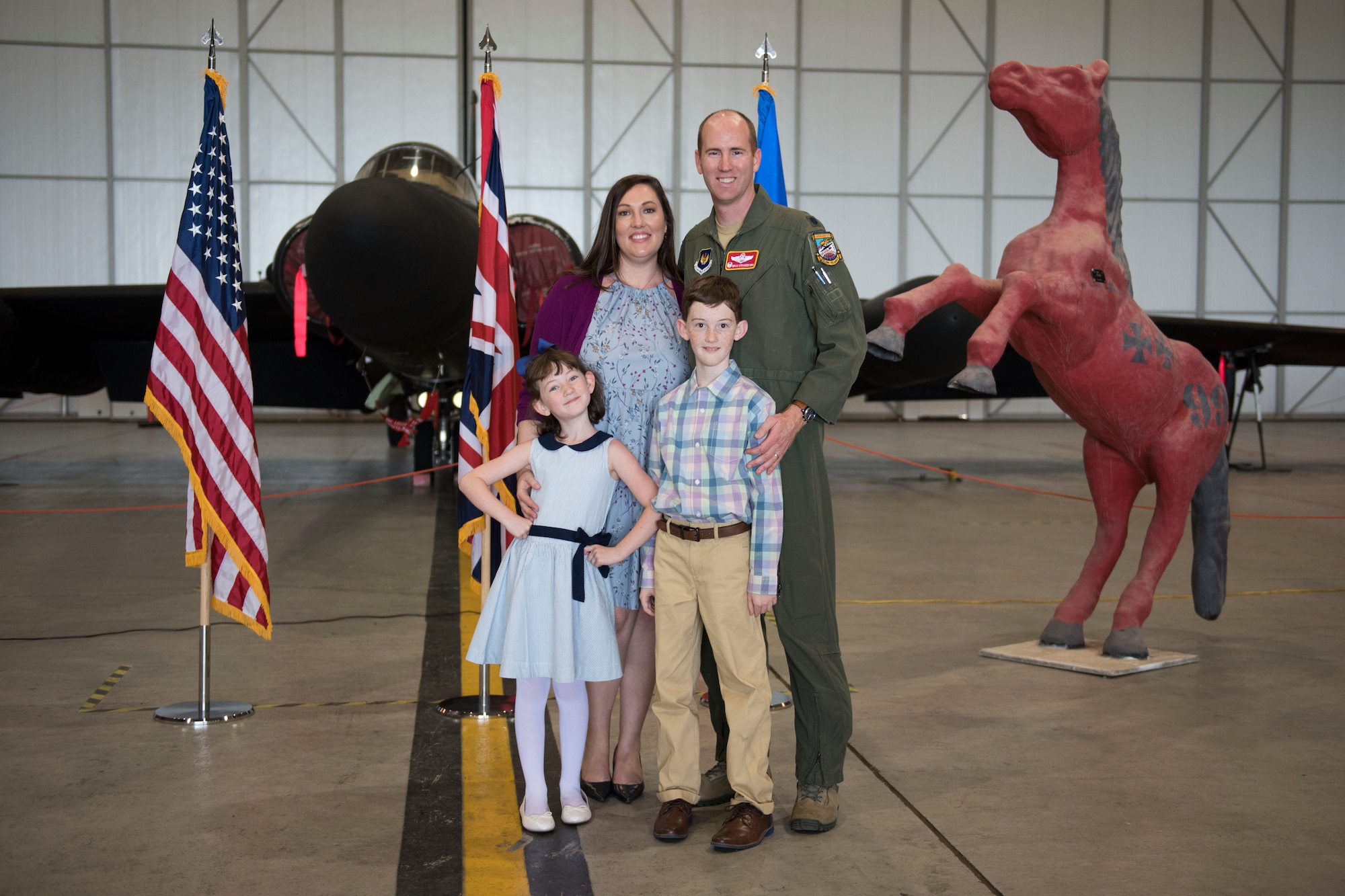 U.S. Air Force Lt. Col. Brian Staniszewski, 99th Expeditionary Reconnaissance Squadron commander, poses for a family photo during a change of command ceremony, at RAF Fairford, England, June 24, 2020. The change of command ceremony is a military tradition that represents a formal transfer of a unit’s authority and responsibility from one commander to another. (U.S. Air Force photo by Airman 1st Class Jennifer Zima)