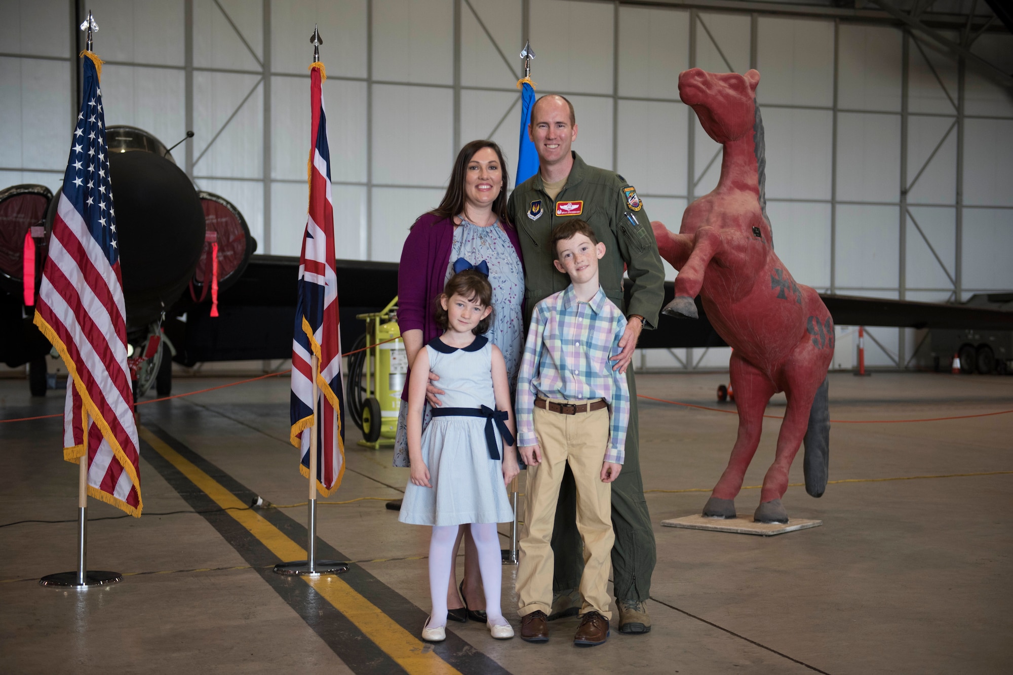 U.S. Air Force Lt. Col. Brian Staniszewski, 99th Expeditionary Reconnaissance Squadron commander, poses for a family photo during a change of command ceremony, at RAF Fairford, England, June 24, 2020. The change of command ceremony is a military tradition that represents a formal transfer of a unit’s authority and responsibility from one commander to another. (U.S. Air Force photo by Airman 1st Class Jennifer Zima)