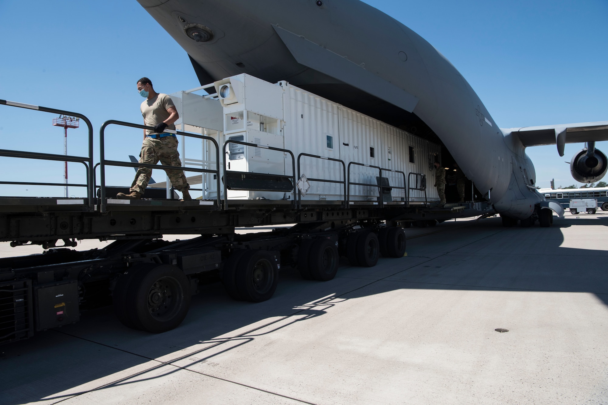 U.S. Air Force personnel assigned to the 721st Aerial Port Squadron off-load a Negatively Pressured Conex from a C-17 Globemaster III aircraft