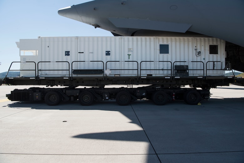 A Negatively Pressured Conex sits on a k-loader after 721st Aerial Port Squadron personnel unloaded it from a C-17 Globemaster III