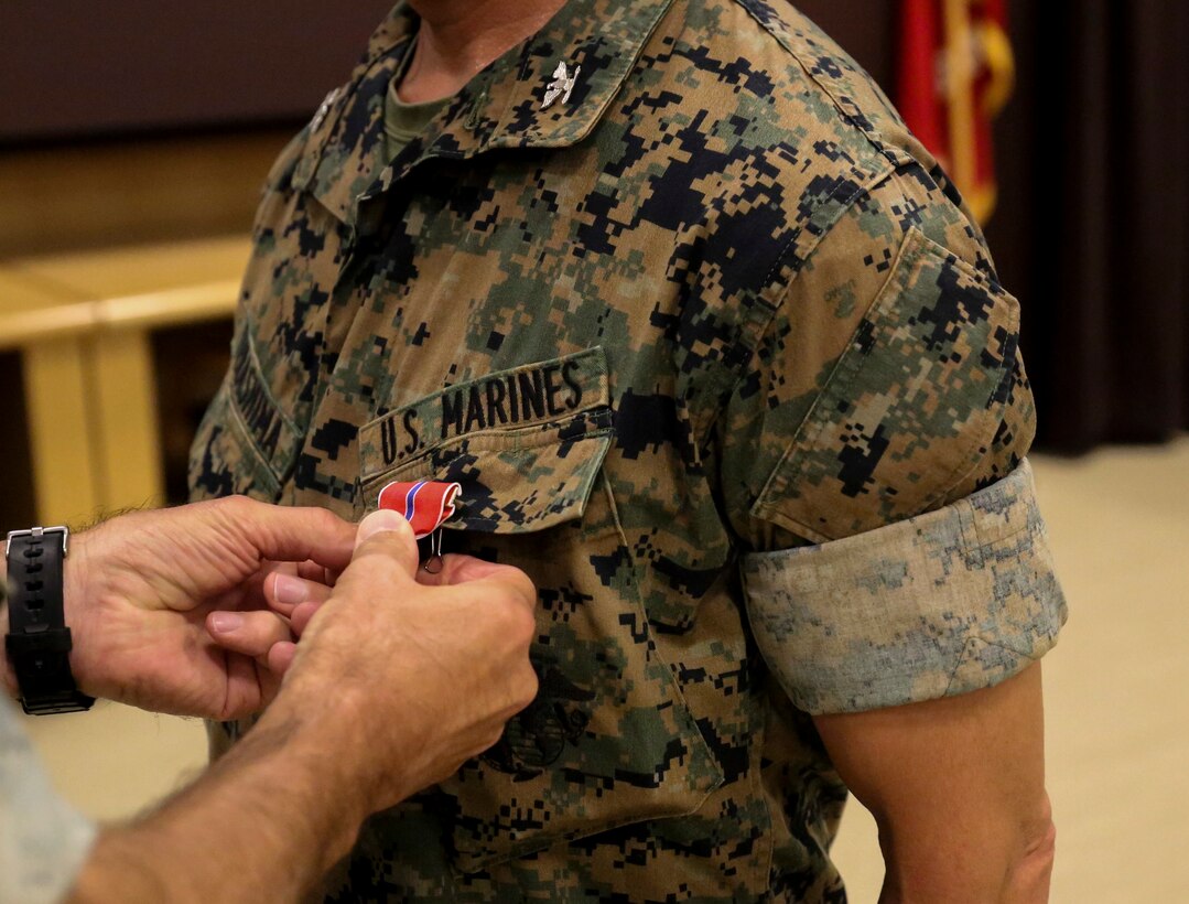 U.S. Marine Corps Col. Eric K. Terashima, senior reserve integrator with II Marine Expeditionary Force, poses for a photo with Brig. Gen. David L. Odom, commanding general of 2nd Marine Expeditionary Brigade, after receiving a bronze star medal with a gold star in lieu of second award for his actions during Operation Freedom’s Sentinel on Camp Lejeune, N.C., June 25, 2020. As senior advisor to the Helmand and Nimroz Afghan National Police, he negotiated dynamic, physical and human terrain of southwest Afghanistan. (U.S. Marine Corps photo by Lance Cpl. Samuel Lyden)