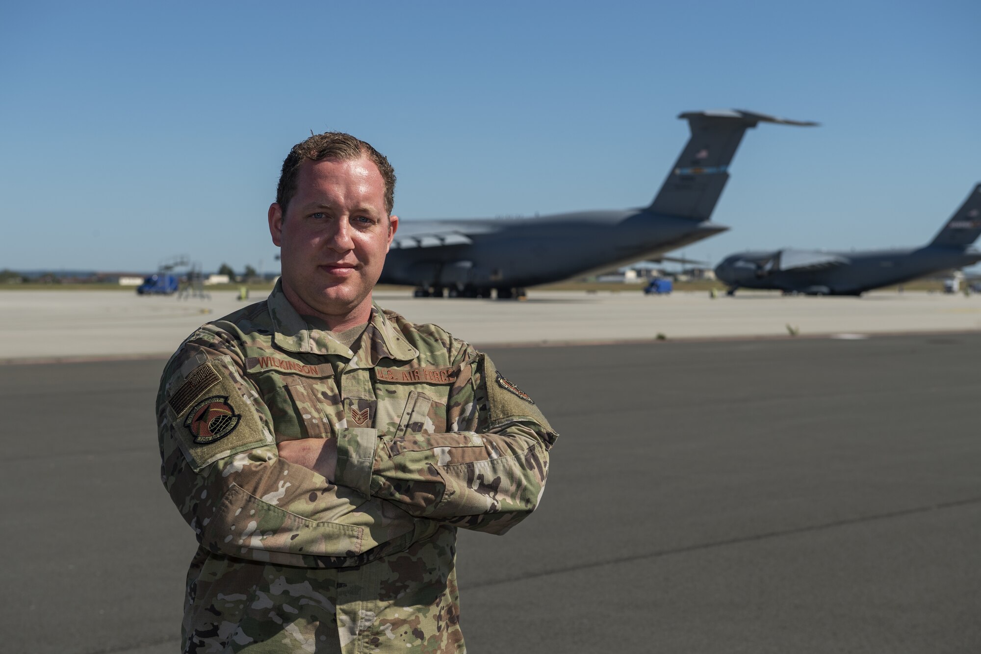 U.S. Air Force Staff Sgt. Michael Wilkinson, 726th Air Mobility Squadron aerospace maintenance craftsman, poses for a photo on the flightline at Spangdahlem Air Base, Germany, June 24, 2020. Wilkinson is credited with saving the life of an impaired trucker who had gone off the road on the German Autobahn. (U.S. Air Force photo by Senior Airman Branden Rae)