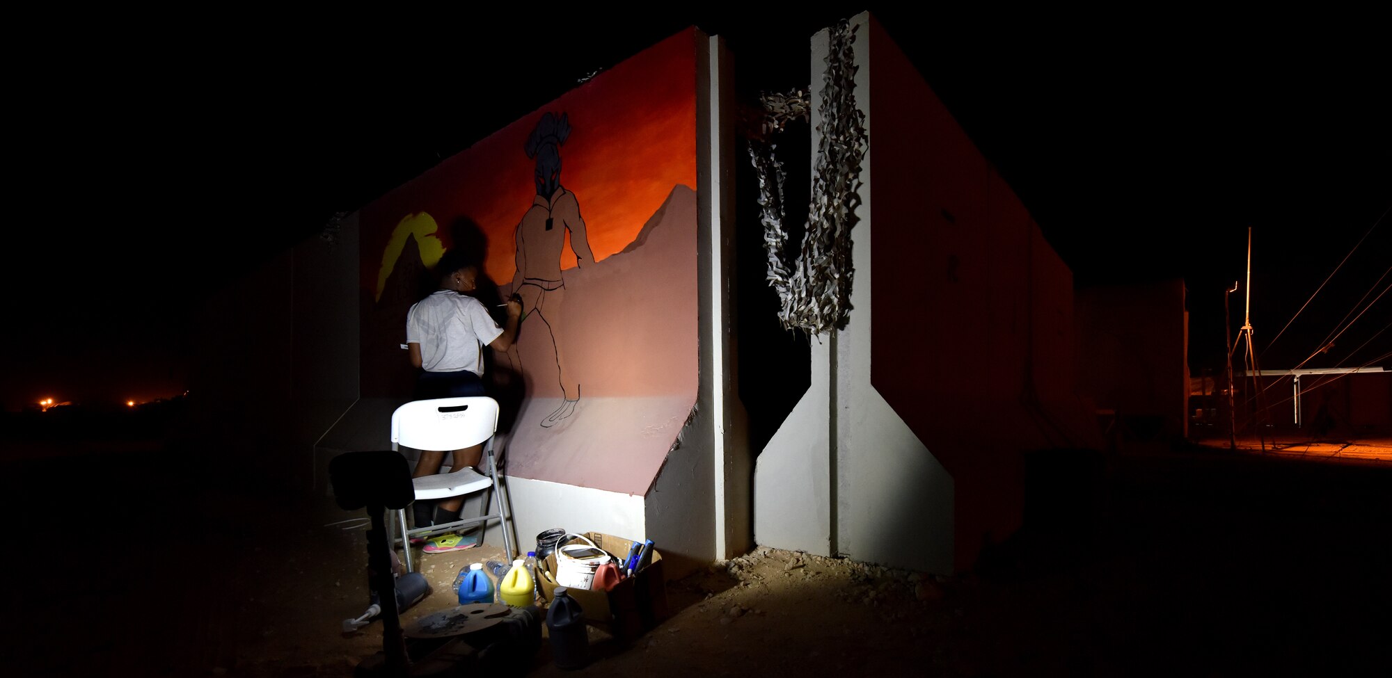 An Airman from the 378th Expeditionary Security Forces Squadron paints a Squadron emblem at Prince Sultan Air Base, Kingdom of Saudi Arabia. Several units around base are developing logos and symbols to boost morale and pride in each unit.