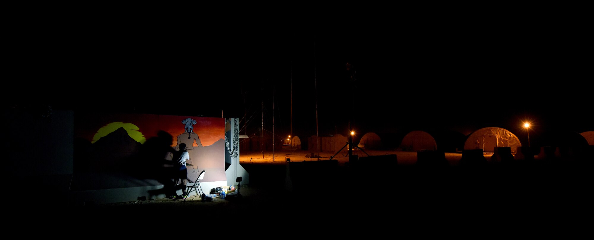 An Airman from the 378th Expeditionary Security Forces Squadron paints a Squadron emblem at Prince Sultan Air Base, Kingdom of Saudi Arabia. Several units around base are developing logos and symbols to boost morale and pride in each unit.