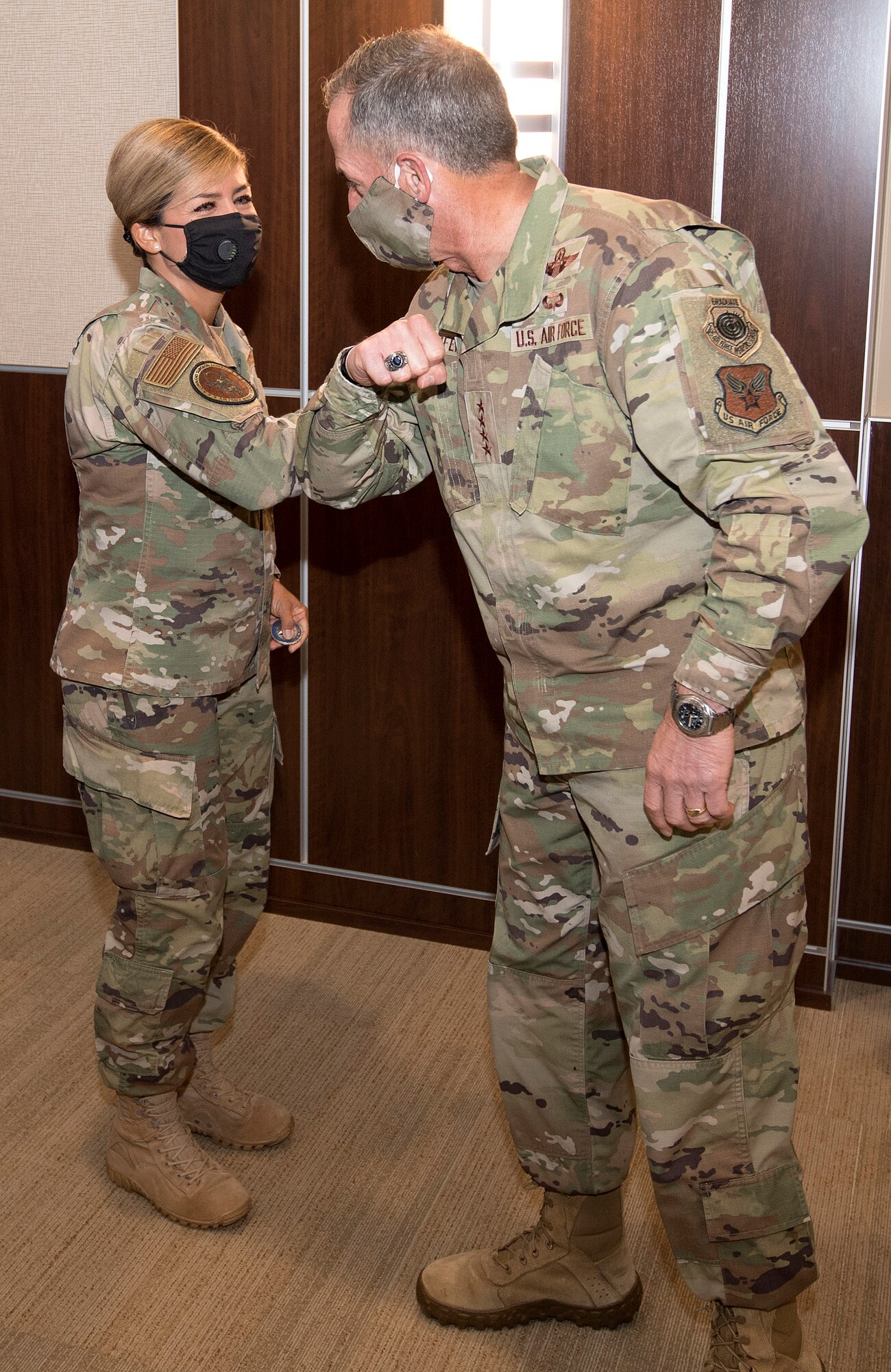 Photo of Air Force Chief of Staff Gen. David L. Goldfein, elbow bumping Air Force Reserve Command Public Health Officer Lt. Col. Jessica Dees after giving her a coin for her contributions in the battle against COVID-19 at Robins Air Force Base, Georgia, June 24, 2020.