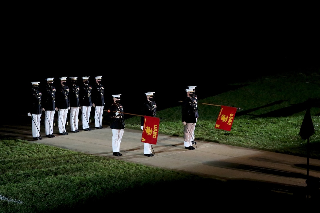 Marines with Marine Barracks Washington salute during the “officers center” sequence at the Friday Evening Parade, June 26, 2020. Following Department of Defense guidelines and Centers for Disease Control and Prevention (CDC) recommendations, Marines are wearing cloth face coverings during parades this year in an effort to maximize the health and safety of Barracks personnel and guests. The hosting official for the evening was Col. Teague A. Pastel, commanding officer, Marine Barracks Washington, and the 38th Commandant of the Marine Corps, Gen. David H. Berger, was the guest of honor. (U.S. Marine Corps photo by Cpl. James Bourgeois)