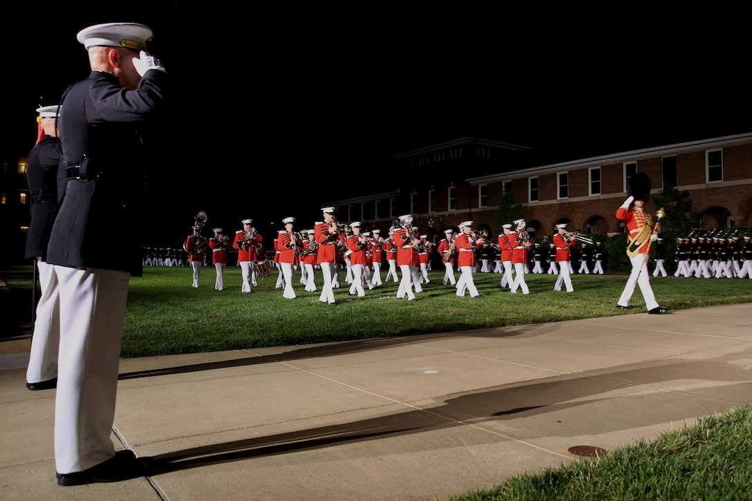 Master Gunnery Sgt. Duane King, drum major, “The President’s Own,” United States Marine Band, salutes Gen. David H. Berger, the 38th Commandant of the Marine Corps, and Col. Teague A. Pastel, the Marine Barracks Washington commanding officer, during “pass in review” at the Friday Evening Parade, June 26, 2020. To maximize safety precautions during this year’s parade season, “The President’s Own” reduced the number of marching musicians from 36 to 25 and spread out their formation to increase physical distancing between the Marines. The hosting official for the evening was Col. Teague A. Pastel, commanding officer, Marine Barracks Washingto, and the 38th Commandant of the Marine Corps, Gen. David H. Berger, was the guest of honor. (U.S. Marine Corps photo by Cpl. James Bourgeois)