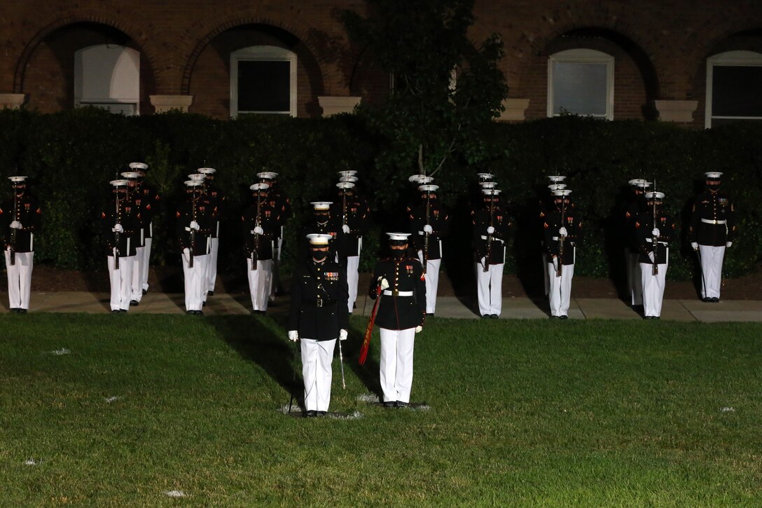 Marines with Company B salute during the Friday Evening Parade at Marine Barracks Washington, D.C., June 26, 2020. Following Department of Defense guidelines and Centers for Disease Control and Prevention (CDC) recommendations, Marines are wearing cloth face coverings during parades this year in an effort to maximize the health and safety of Barracks personnel and guests. The hosting official for the evening was Col. Teague A. Pastel, commanding officer, Marine Barracks Washington, and the 38th Commandant of the Marine Corps, Gen. David H. Berger, was the guest of honor. (U.S. Marine Corps photo by Sgt. Robert Knapp)